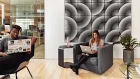 photo of two people working on their laptops