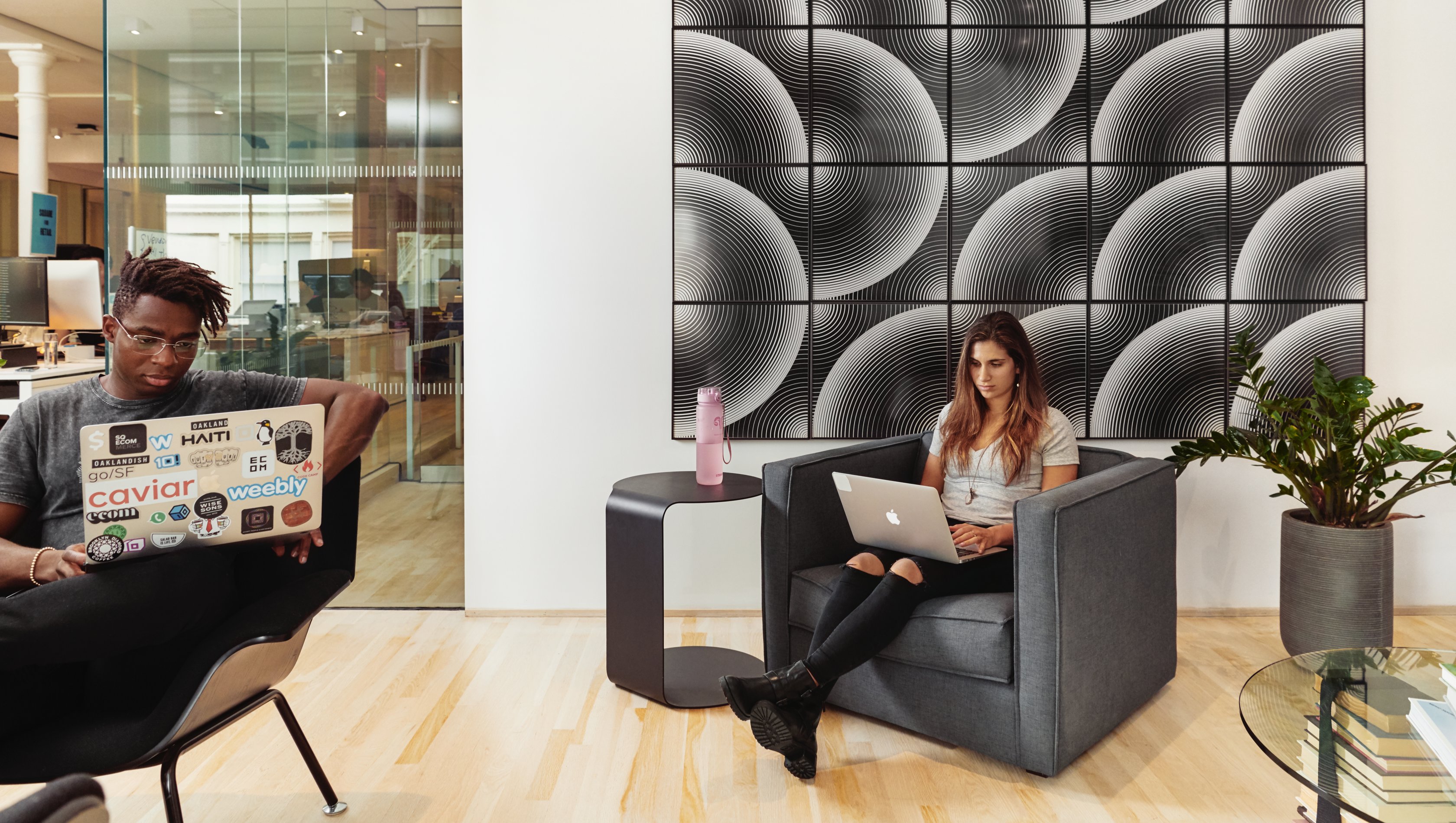photo of two people working on their laptops