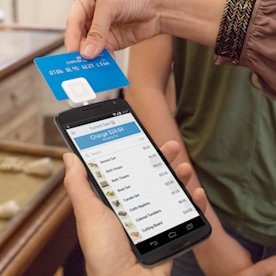 Photo of someone swiping a credit card through Square Reader for magstripe in a retail store