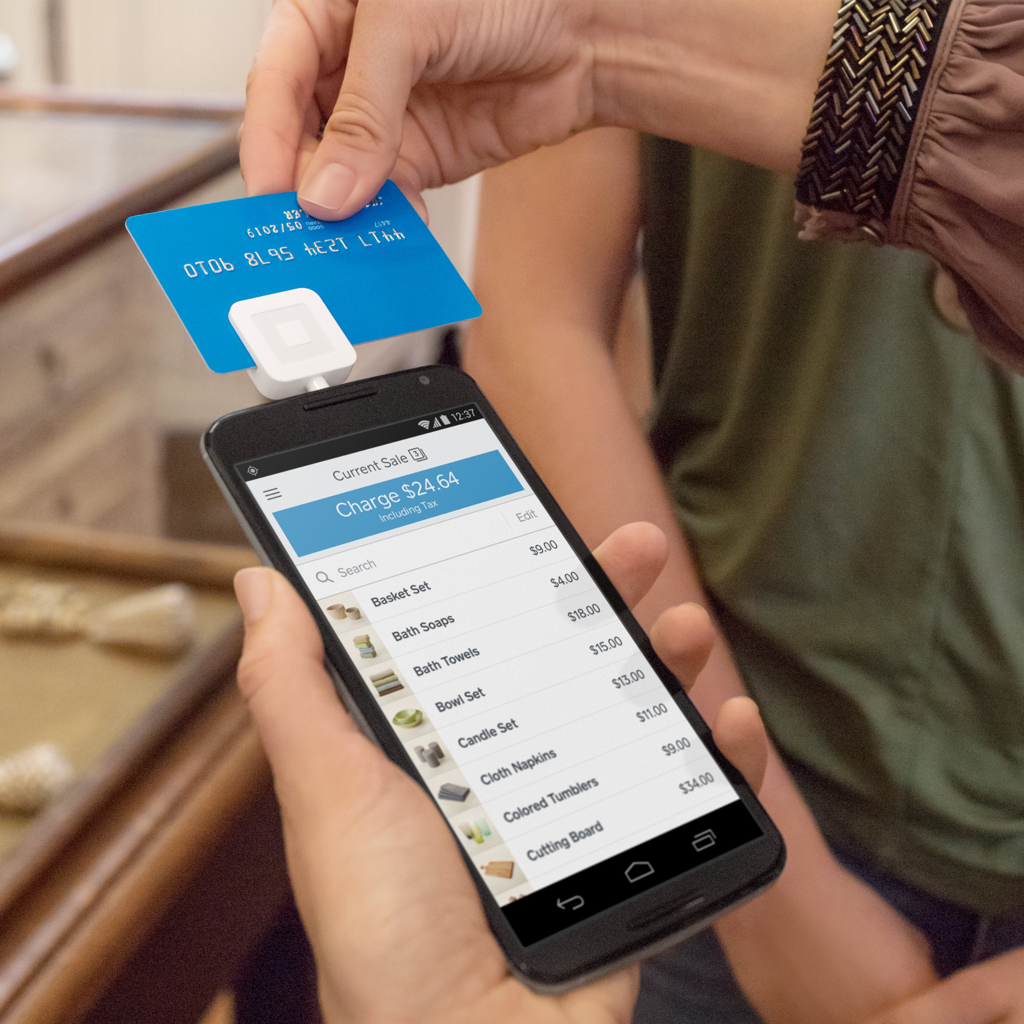 Photo of someone swiping a credit card through Square Reader for magstripe in a retail store