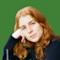 A headshot of Kate Cavanaugh on a green background