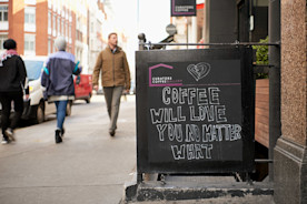 how to create a coffee shop marketing plan, image of a sidewalk promotion for a coffee shop