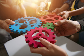 Teamwork of businesspeople work together and combine pieces of gears. Partnership and integration concept