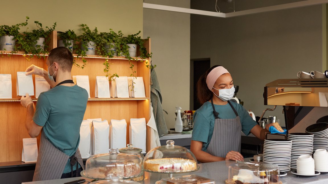 Cafe workers on the first day of work, representing advice on how to hire employees quickly.