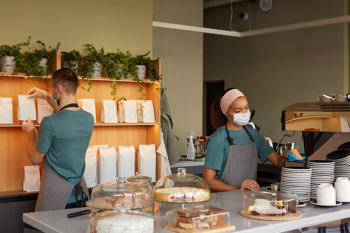 Cafe workers on the first day of work, representing advice on how to hire employees quickly.