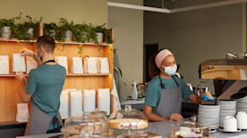 Cafe workers on the first day of work, representing advice on how to hire employees quickly.
