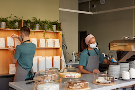Cafe workers on the first day of work, representing advice on how to hire employees quickly.