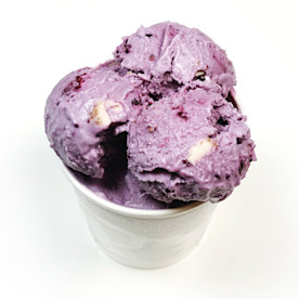 a white tub of purple textured ice cream