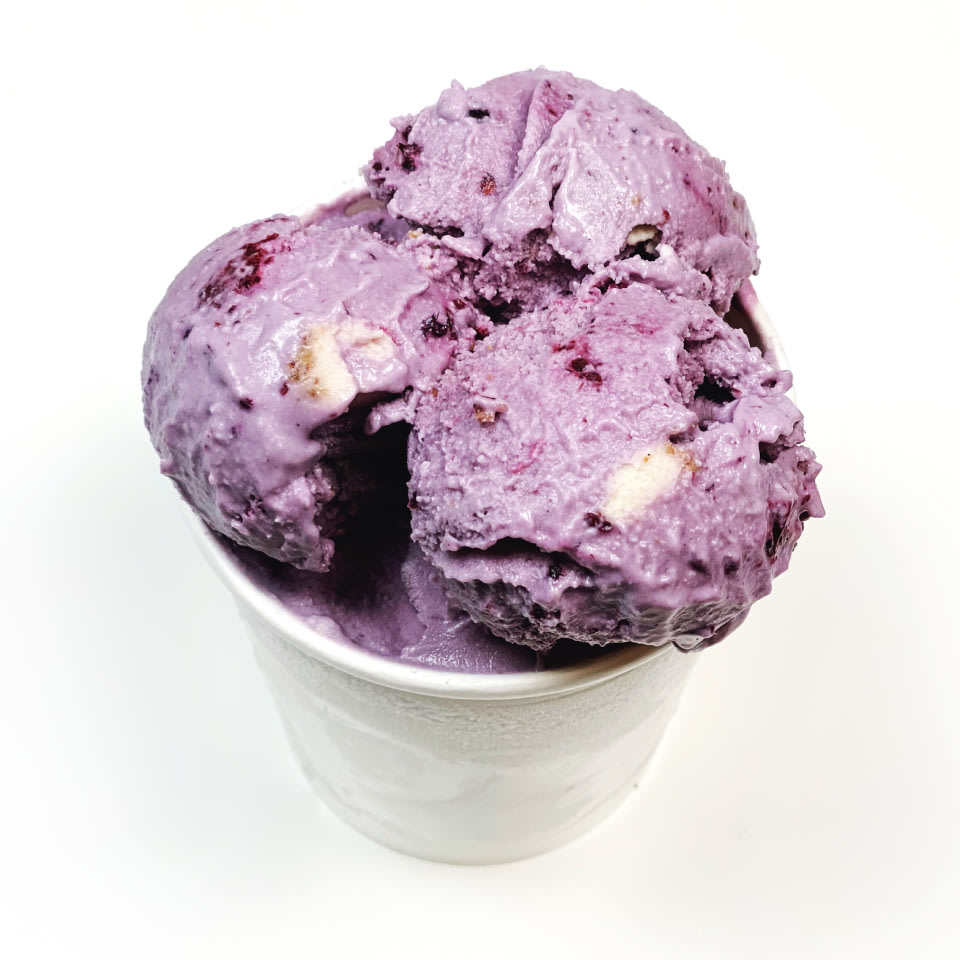 a white tub of purple textured ice cream