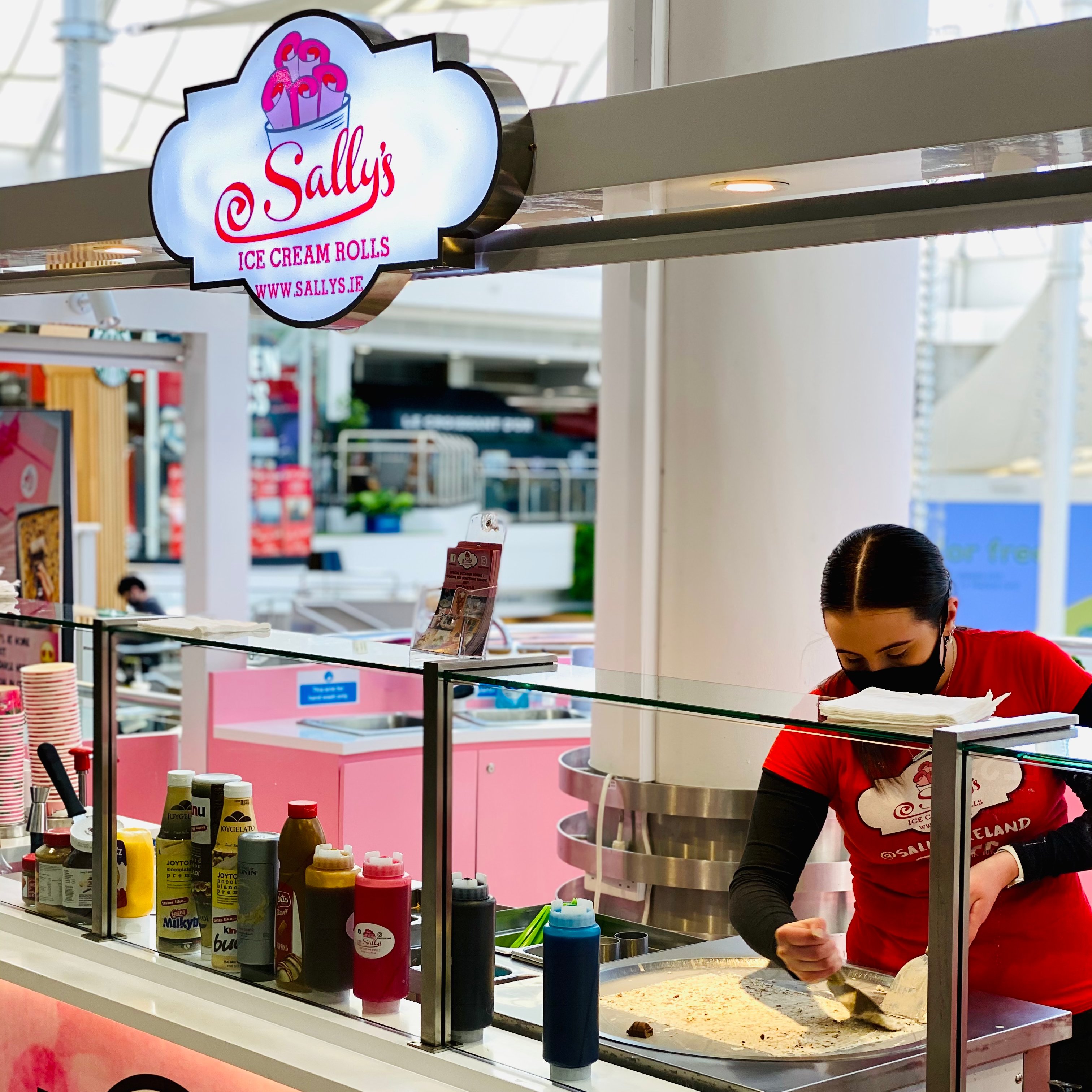Sally's staff preparing hand rolled ice cream in the kiosk at Tallagh Shopping Center