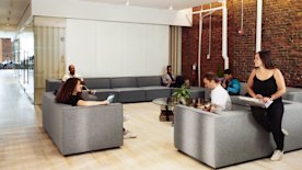 photo of people sitting on couches and working