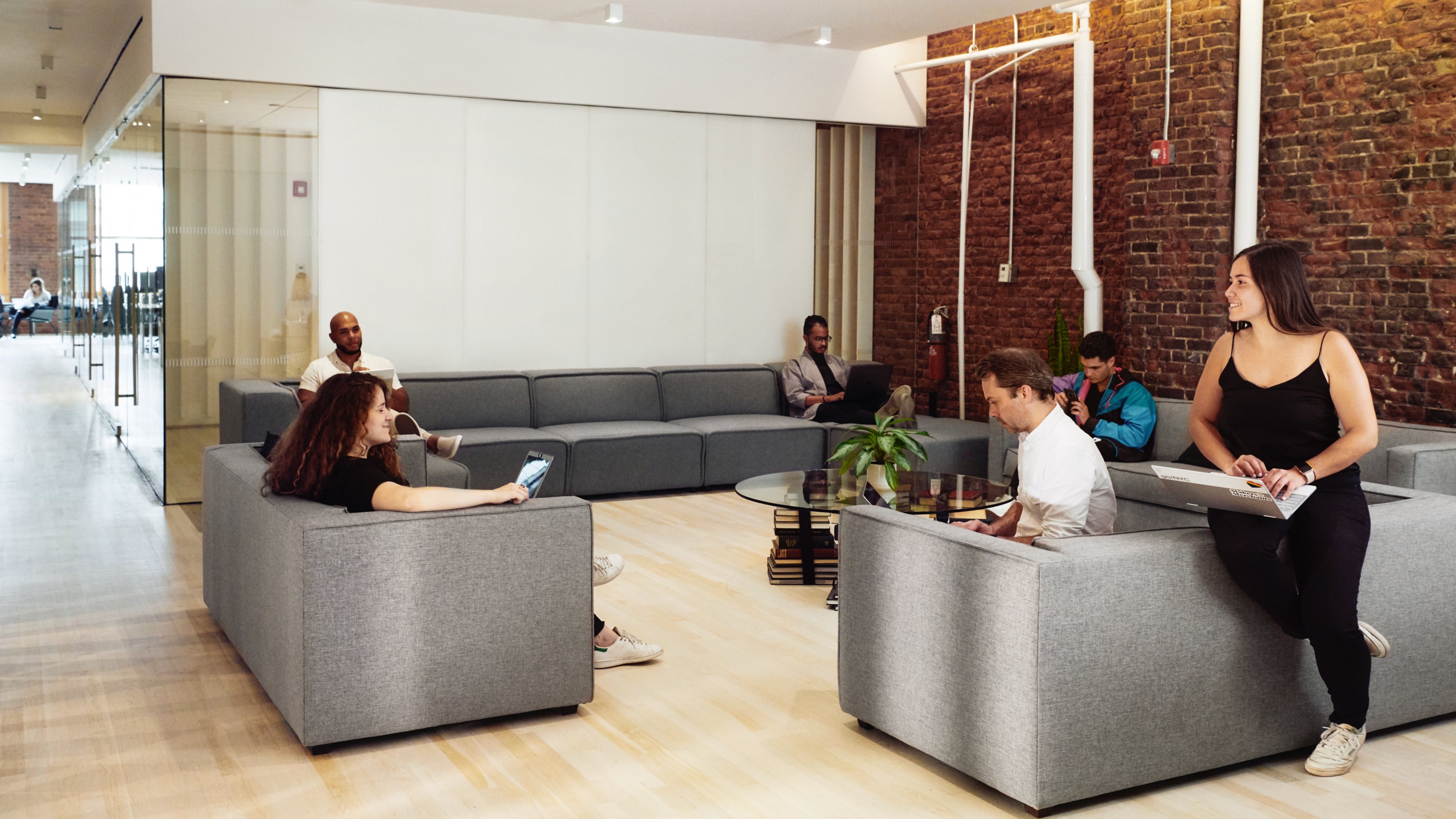 photo of people sitting on couches and working