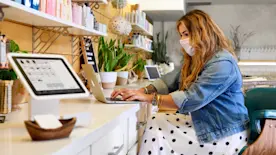 salon owner cutting client's hair