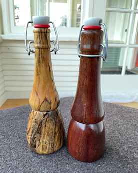 two wooden pepper grinders