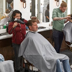 Photo of a man getting his hair blow dried at a hair salon
