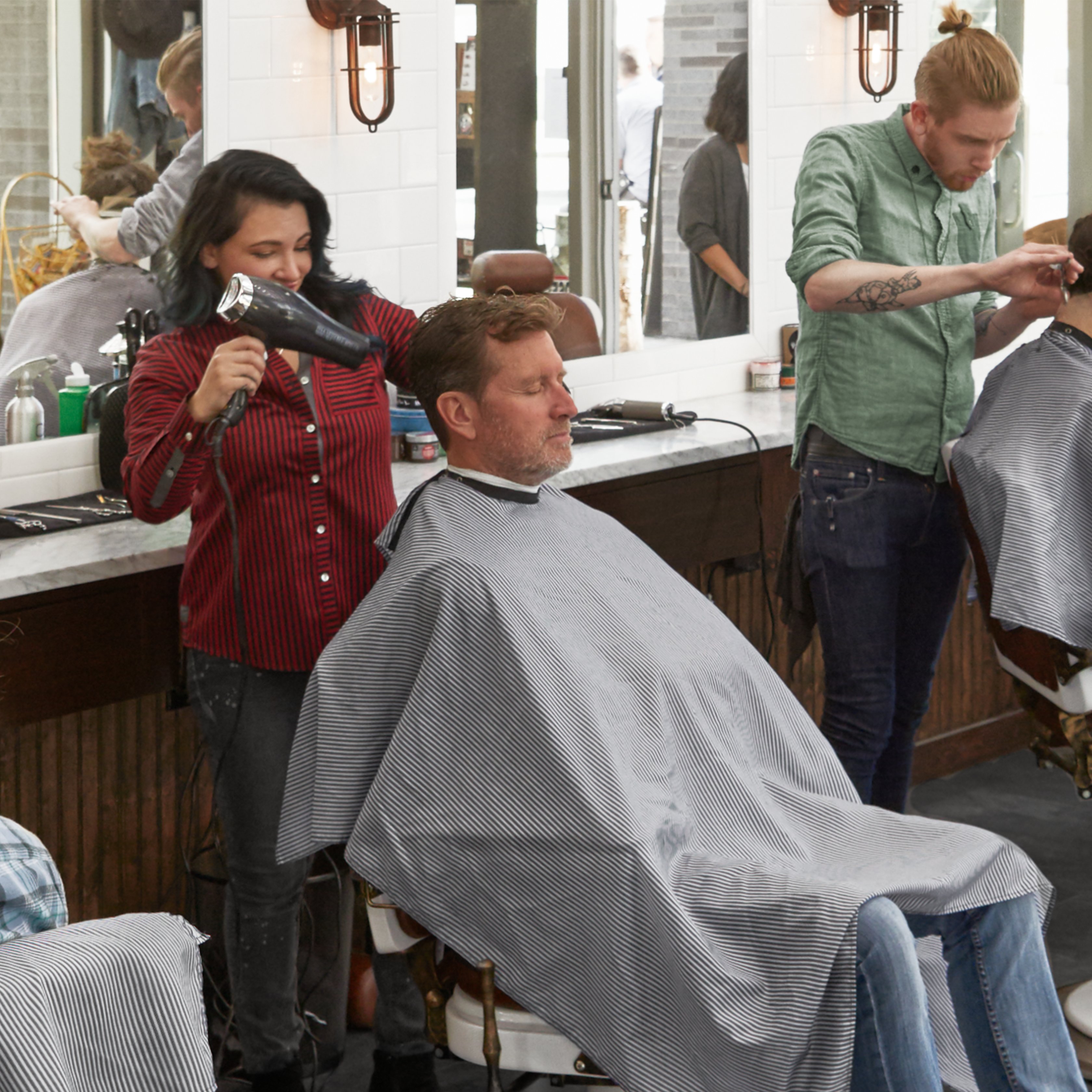 Photo of a man getting his hair blow dried at a hair salon