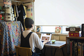 A business owner on their laptop managing their online ordering page