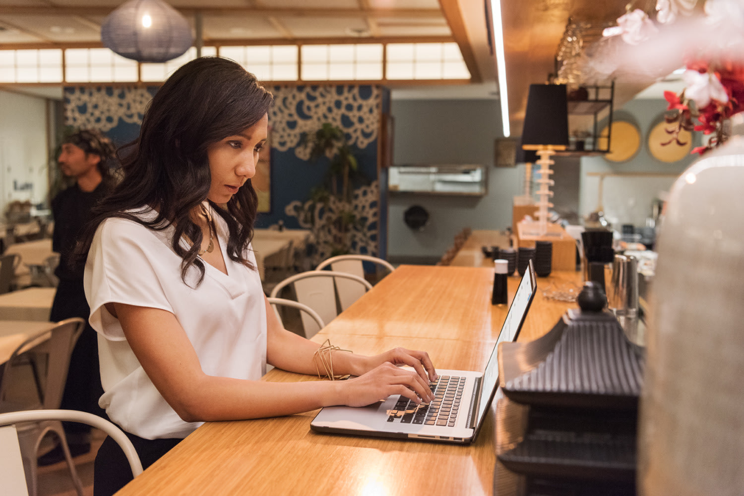 woman working on laptop in restaurant
