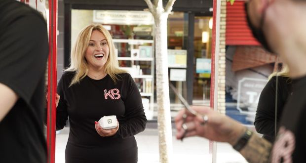 Leslie Guigley, owner of Killiney Barbers, holding at T2