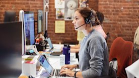 photo of a person working with a headset on