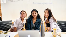 photo of 3 people with a whiteboard behind them