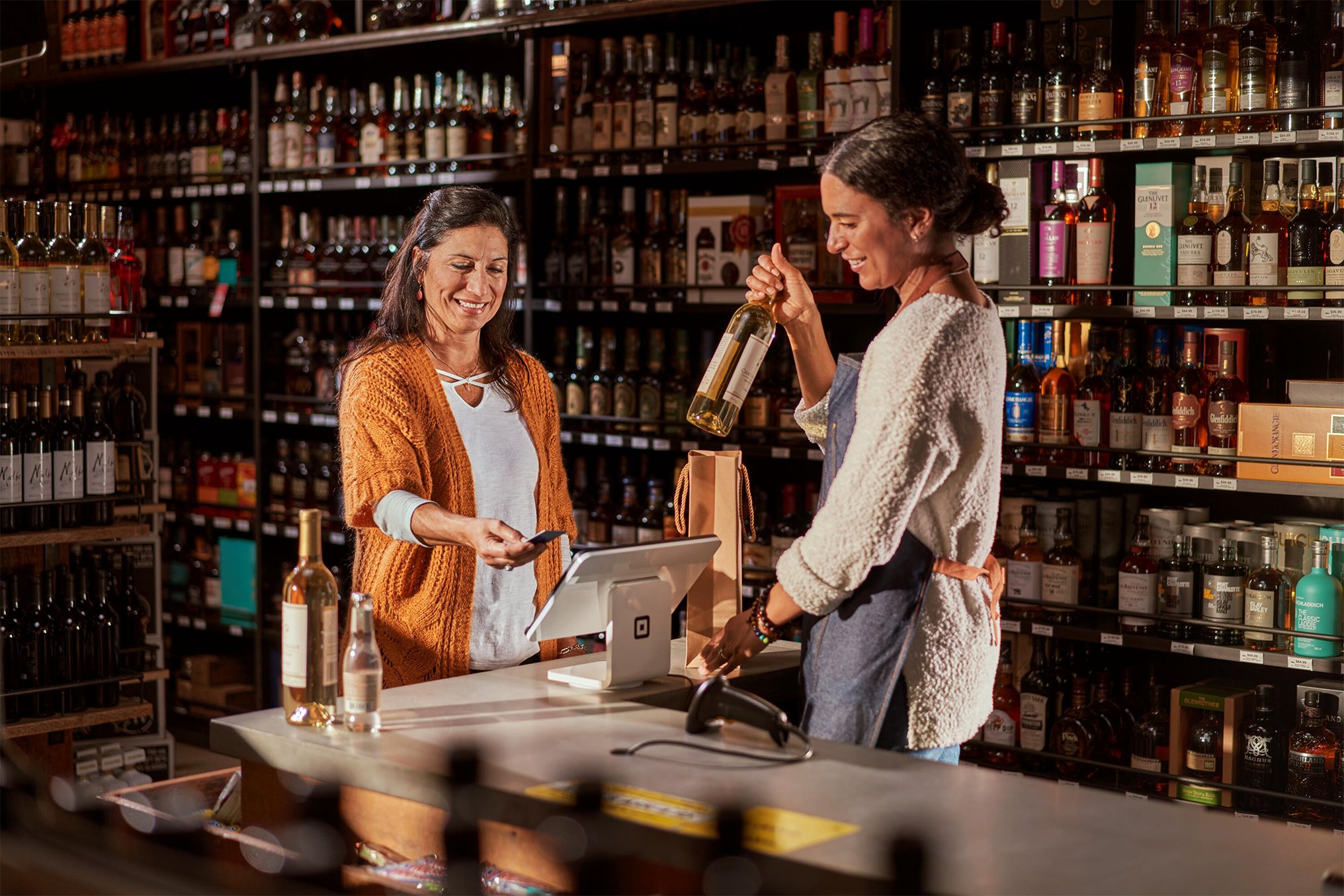 Business owner holding an open sign after she registered her business