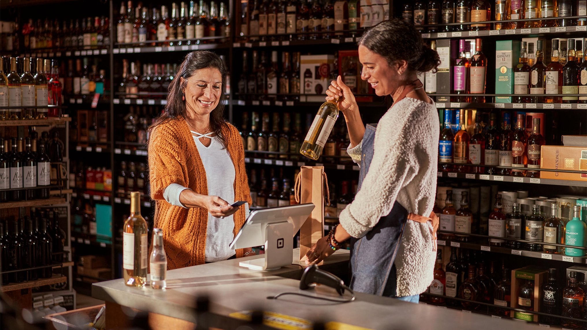 Business owner holding an open sign after she registered her business