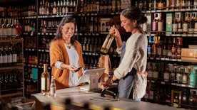 Business owner holding an open sign after she registered her business