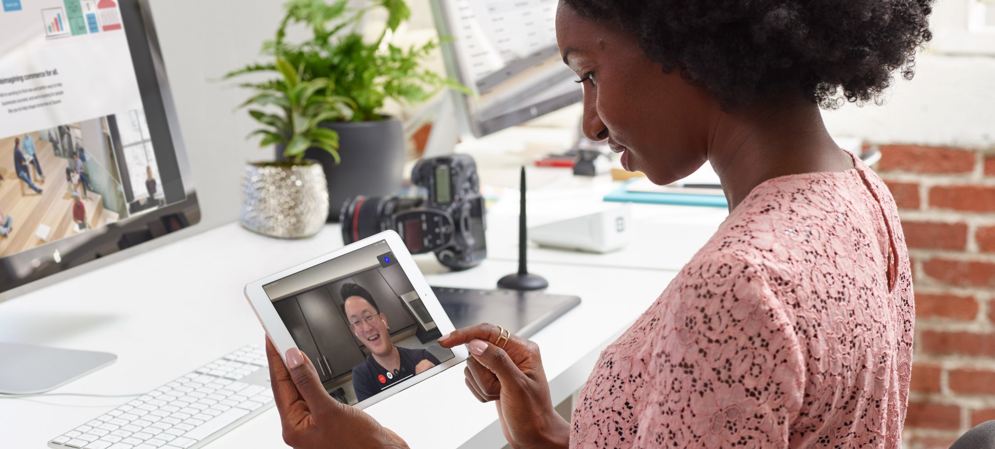 photo showing a person using a tablet to take a video call