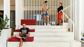 photo of a person working and two people talking