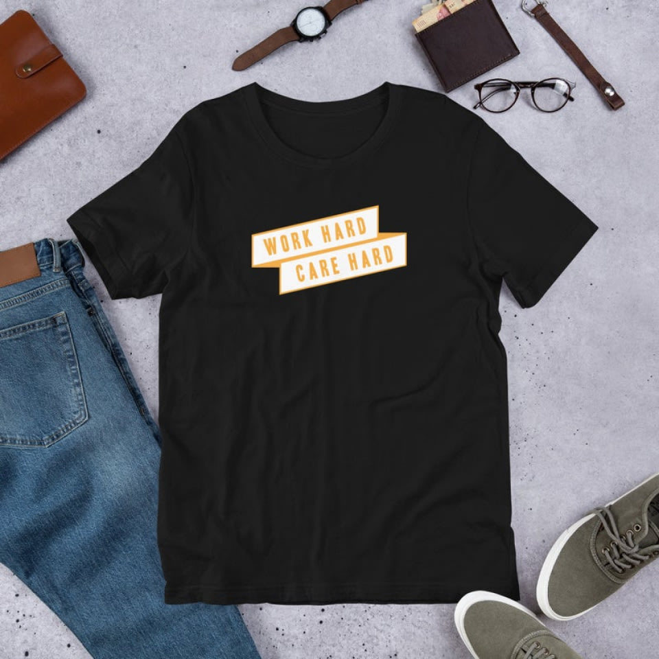 an overhead photo of clothes and accessories with a black t-shirt that reads WORK HARD CARE HARD