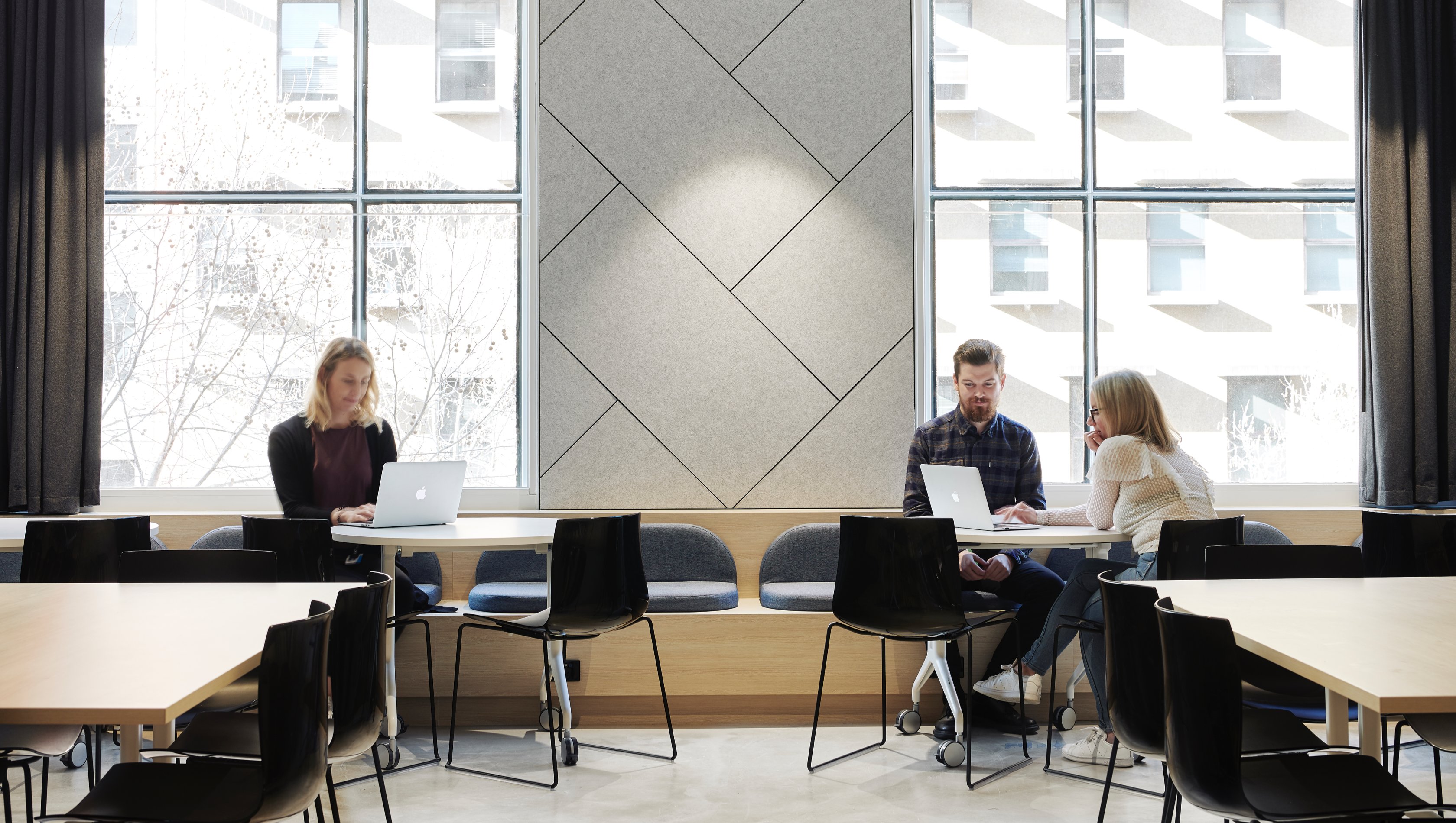 photo of three people working with windows behind them