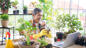 Shop owner selling plants via livestream video.