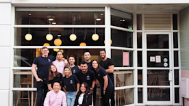 Nomo staff in front of their restaurant