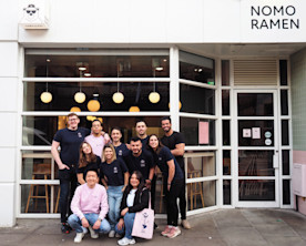 Nomo staff in front of their restaurant