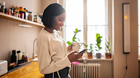 Woman using a mobile phone at home.