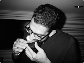 Photo of Neil Shankar eating a cupcake