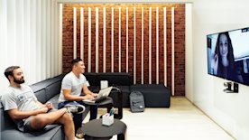 photo of two people in a conference room taking a video call