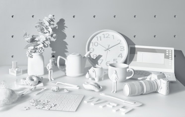 a photo of an assortment of white objects on a white table surface with a white pegboard in the background