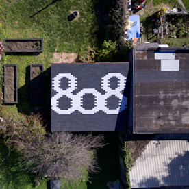 arial photo of a building showing the numbers 808 designed on a rooftop