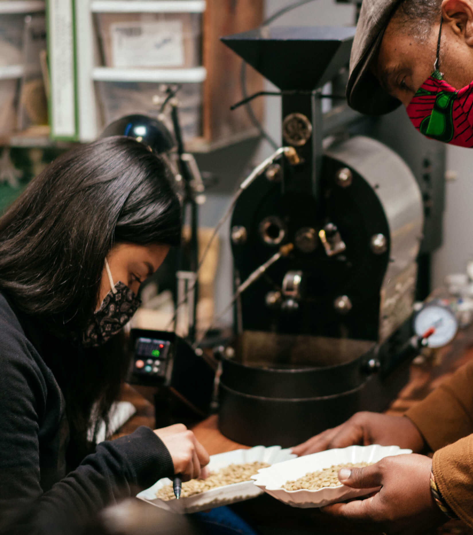 Red Bay Coffee founder Keba Konte and an employee inspect raw coffee beans.