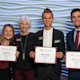 Four students from the University of South Carolina pose and hold their winning certificate from the Darla Moore School of Business Annual Sales Competition