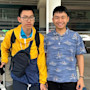 Hung and Hieu, two brothers from Vietnam studying at the University of Utah, stand at the airport with their luggage and smile for the camera