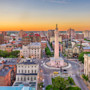 This image shows an aerial view of Mount Vernon place in downtown Baltimore at sunset.