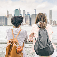 Two international students looking at a waterside view of NYC
