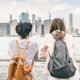 Two international students looking at a waterside view of NYC