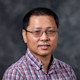 Libo, an Auburn University alum from China, smiles for the camera in a professional head shot