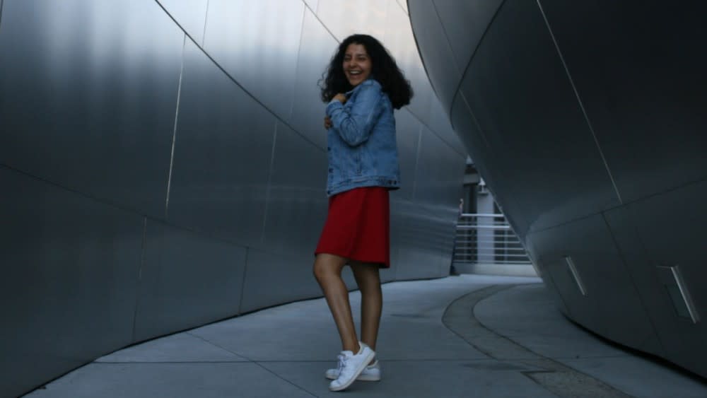 Mariana, an international student from Mexico at American Collegiate Los Angeles, smiles while standing on the beach