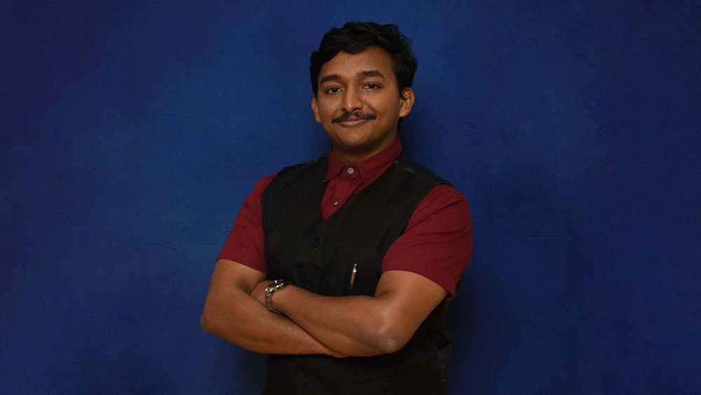 Sabin, a University of Dayton alum from India, stands and smiles for the camera.