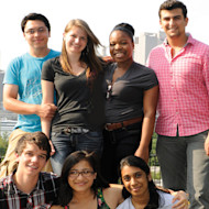 A group of international students posing for a picture with New York City in the background